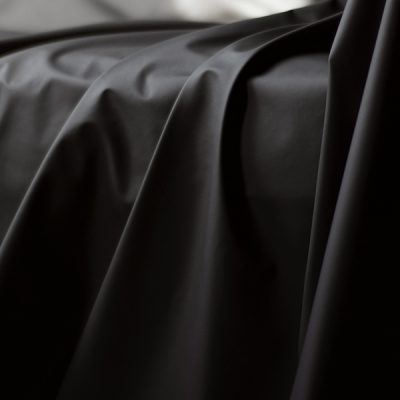 Black Fluidproof sheet showing drapes and folds